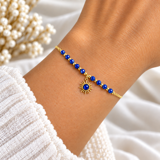 Élégant et délicat, ce bracelet associe une fine chaîne dorée à de petites perles bleues et de délicates perles dorées, pour un rendu raffiné et féminin.